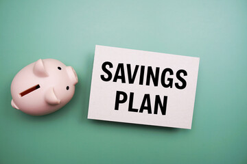 Savings Plan text and piggy bank for saving on green background