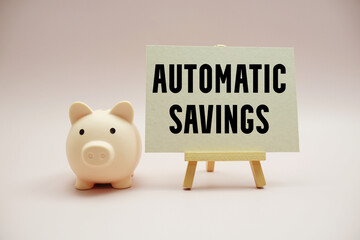 Automatic Savings text and piggy bank for saving on pink background