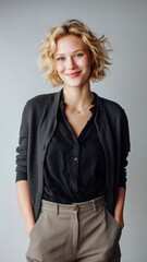 Studio Portrait of a young woman, soft natural lightning, casual outfit, light grey background, realistic photograph