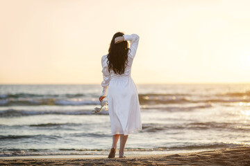 The bride's honeymoon along the ocean shore, love and feelings of a beautiful girl.
