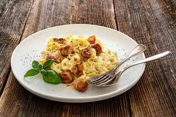 Classic creamy chicken alfredo fettuccine pasta on wooden table