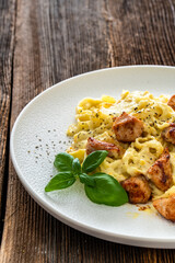 Classic creamy chicken alfredo fettuccine pasta on wooden table