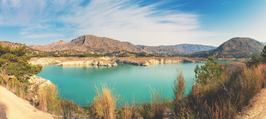 View of a mountain lake on a sunny day in summer. Guadalest  Reservoir in the Guadalest mountain valley, Alicante, Spain, Europe