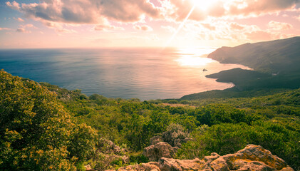 Rocky seascape during sunset. Creiro beach.  Panoramic view of the mountain seashore. Portinho da Arrabida, Setubal region, Atlantic Ocean, Portugal