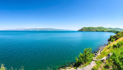 Scenic lake view under clear blue sky.