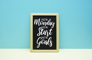 New Monday New Start New Goals text message inspirational quotes on chalkboard with blue and pink...