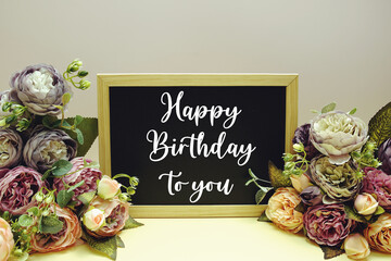 Happy Birthday to you text message with flower decoration on yellow background