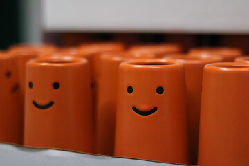Cheerful Orange Cups with Smiling Faces