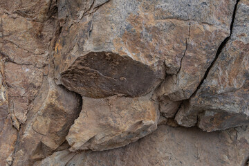 Hard buff sandstone, cobble conglomerate, and micaceous shale (Unnamed Marine Sedimentary Rocks)....