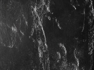 Old scratched black paper texture with white marks, ideal for vintage design and abstract grunge...