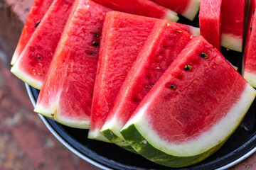 Freshly sliced watermelon on a plate, ready to eat