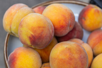 Pile of Fresh, Ripe Peaches Displayed Outdoors