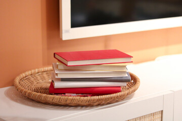 Colorful Stack of Books in a Woven Basket