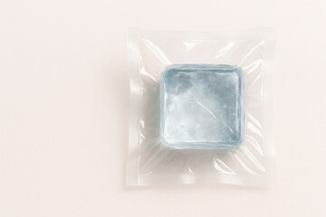 Evacuated cubic ice block on a light background. Space for text.