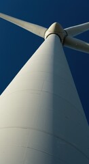 Naklejka premium Low Angle View of White Wind Turbine Against Deep Blue Sky
