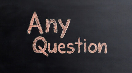 Fototapeta premium A chalkboard with a chalk message asking 'Any Question', suggesting open communication and inquiries.