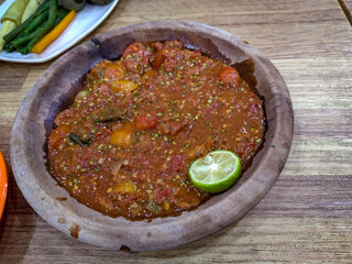 Sambal terasi is a traditional Indonesian chili paste made with chili peppers and terasi (fermented shrimp paste). It is one of the most popular types of sambal across Indonesia, known for its spicy, 