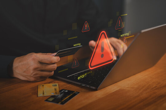 Hacker warning alert during online credit card payment on laptop. Concept of cybersecurity breach, financial fraud, phishing scam, identity theft, digital transaction risks in e-commerce environments.