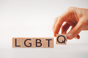 Hand holds Q cube next to LGBT cubes, symbolizing the expansion of LGBTQ+ identity, diversity, and...