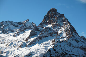 Breathtaking snow-covered mountain peak. Ideal for mountain tourism, challenging climbing, and...