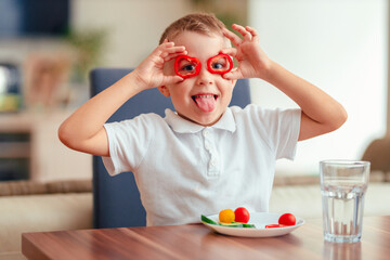 Creative boy playing with vegetables while eating