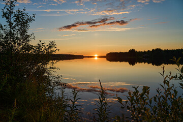 beautiful sunset at a lake in Finland in midsummer.