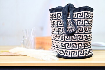 Handmade Crochet Bag with Geometric Pattern Displayed on Wooden Table Indoors