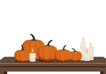 Autumn pumpkins and candles arranged on wooden table for decoration  