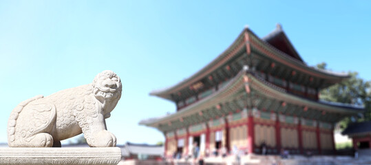 Horizontal banner with stone statue of mythical creature at the ancient pavilion, Gyeongbokgung palace complex, Seoul, South Korea. Topic of summer vacation, travel, trip abroad, cruises and tours