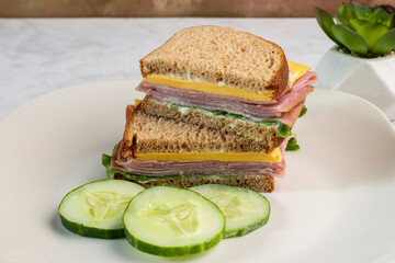 ham  and cheese sandwich served with three pickles