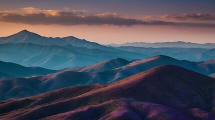Dramatic layered mountain range at sunset with a beautiful gradient sky, peaceful landscape