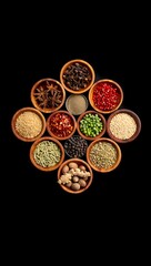 Various spices in wooden bowls on a black background.