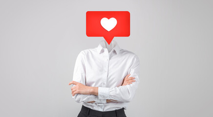 A person in business attire stands with their arms crossed, with heart instead of their head. This represents the importance of love and connection in social media interactions.