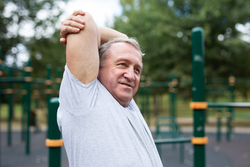 Stretching and active senior man at park for training, exercise and cardio wellness. Fitness, arm...