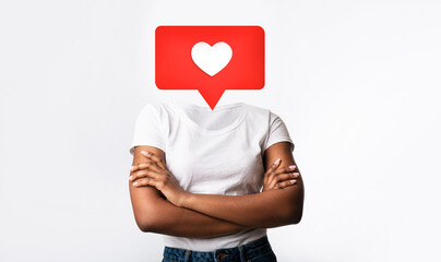 A person stands with arms crossed, featuring a large heart icon instead of their head. This...