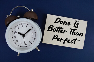 Done Is Better Than Perfect text with alarm clock on blue background