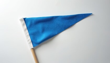 Blue felt pennant on wooden stick with white trim. Blank triangular flag isolated on white background. Represents school spirit, sports teams, retro banners. Offers ample copy space for custom
