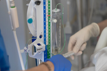 Medical professionals adjusting iv drip in hospital setting