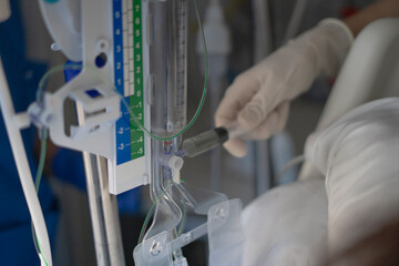 Doctor adjusting iv drip in hospital setting