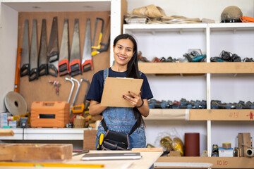 Carpenter working on wooden plank in workshop. Craftsman makes own successful small business, man...