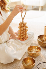 Hand Holding Seed Shaker with Singing Bowls for Meditation and Sound Healing Ritual