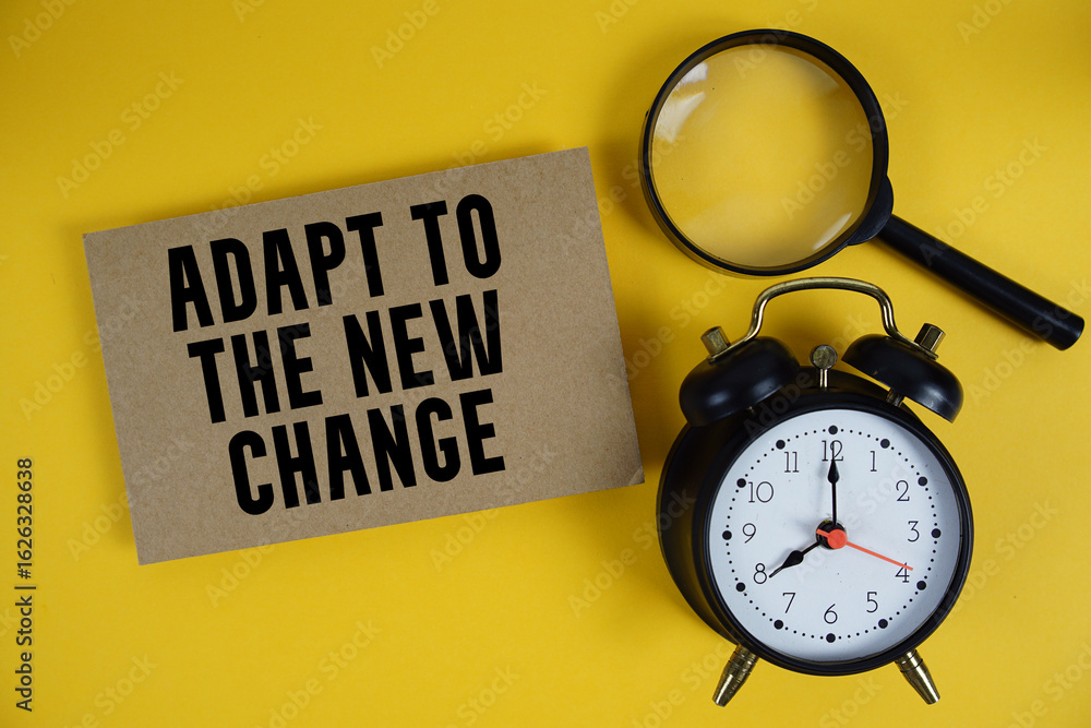 Poster adapt to the new change text written on paper with magnifying glass and alarm clock on yellow backgr