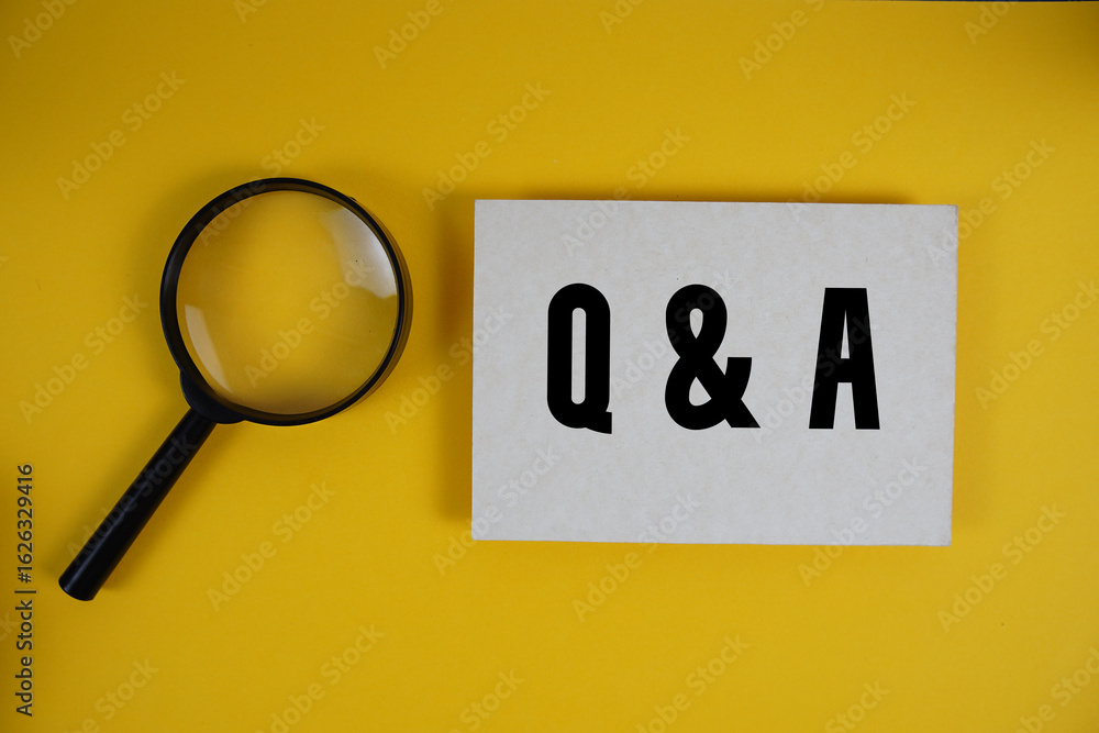 Poster q and a text written on paper with magnifying glass on yellow background