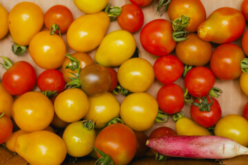 Fresh tomatoes at small local urban market. Organic produce on sale at outdoor farmer market. Selling fresh crops and veggies harvest. European urban setting. Close up. Part of the series