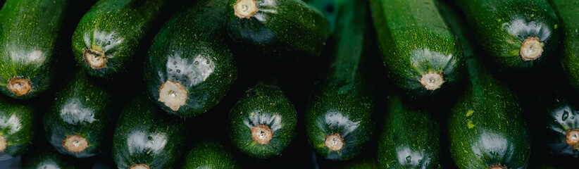Fresh zucchini at small local urban market. Organic produce on sale at outdoor farmer market....