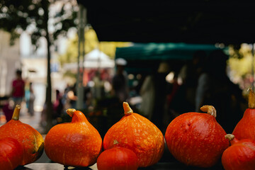 Fresh vegetables at small local urban market. Organic produce on sale at outdoor farmer market. Selling fresh crops and veggies harvest. European urban setting. Close up. Part of the series