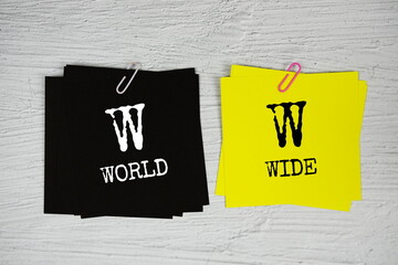 WW - World Wide text on stick note on concrete background