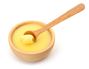 Ghee in a wooden bowl isolated.