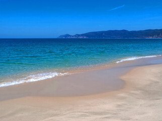 Famous paradise beach in Troia near Lisbon in Portugal with white sand and deep blue sea
