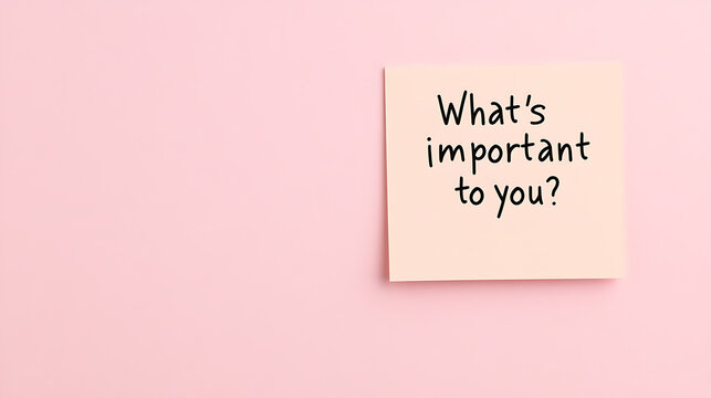 Important question written on sticky note, "What's important to you?" on pink background. Motivational message about goals and life priorities. - Powered by Adobe